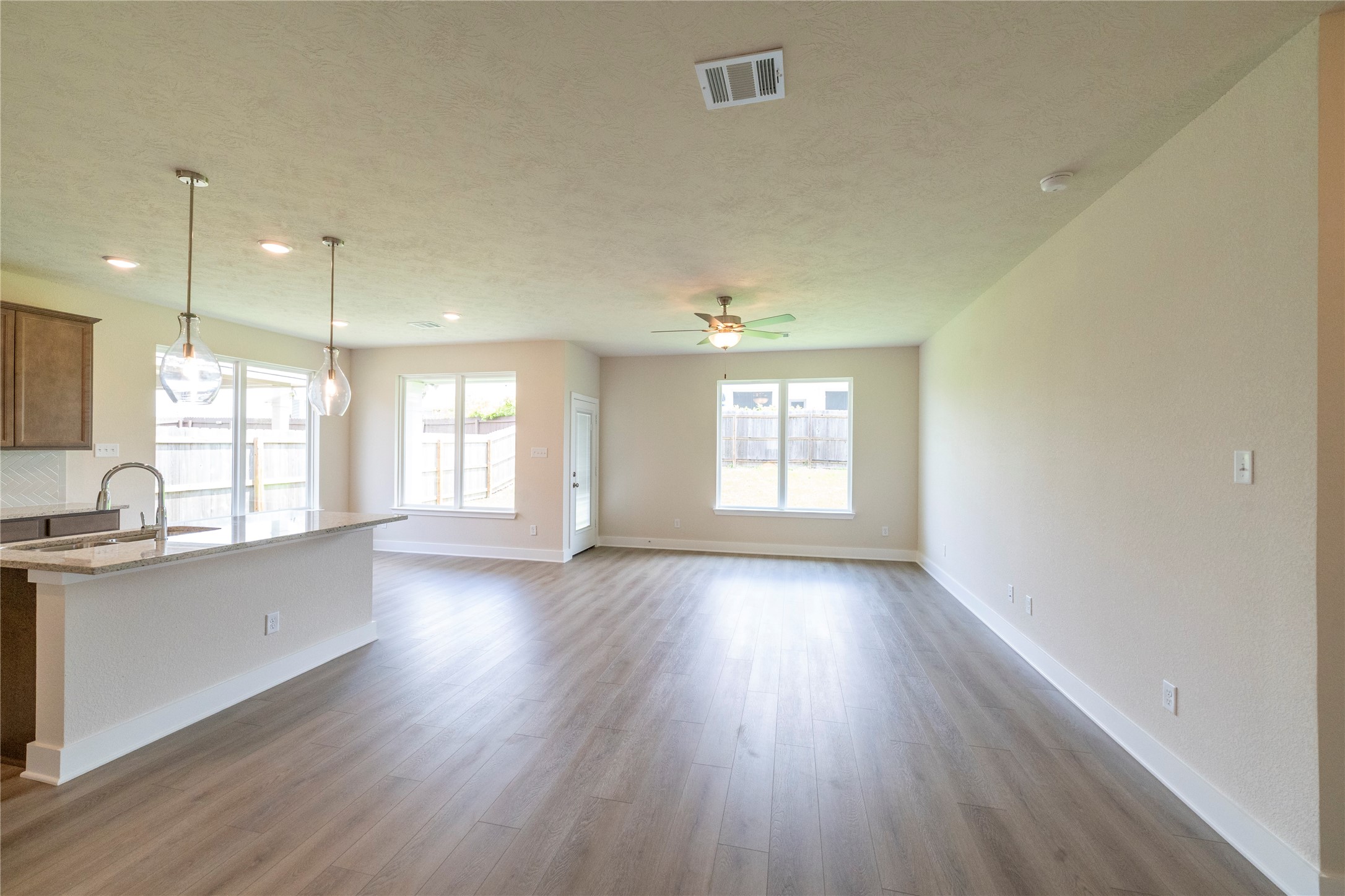 2051 Winepress Road Brenham, TX 77833 - Photo 17 of 31 an empty room with wooden floor and windows