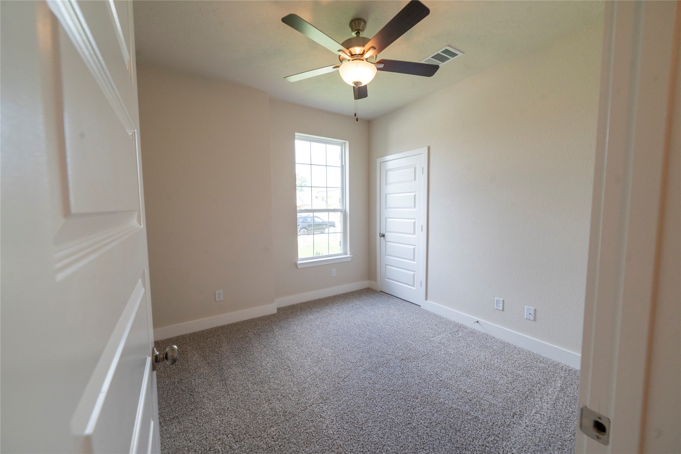 2051 Winepress Road Brenham, TX 77833 - Photo 6 of 31 an empty room with windows and fan