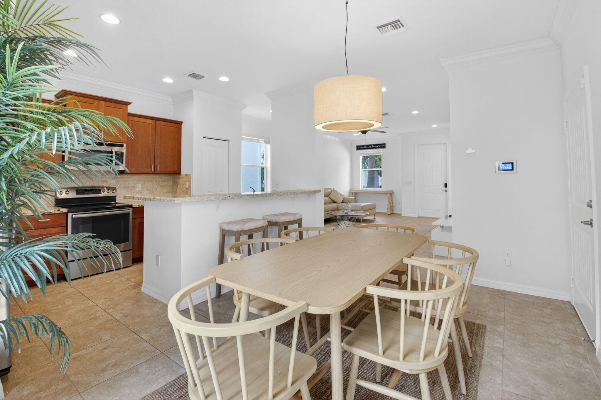3630 Wolf Run Lane Boynton Beach, FL 33435 - Photo 15 of 59 a kitchen with a table and chairs in it