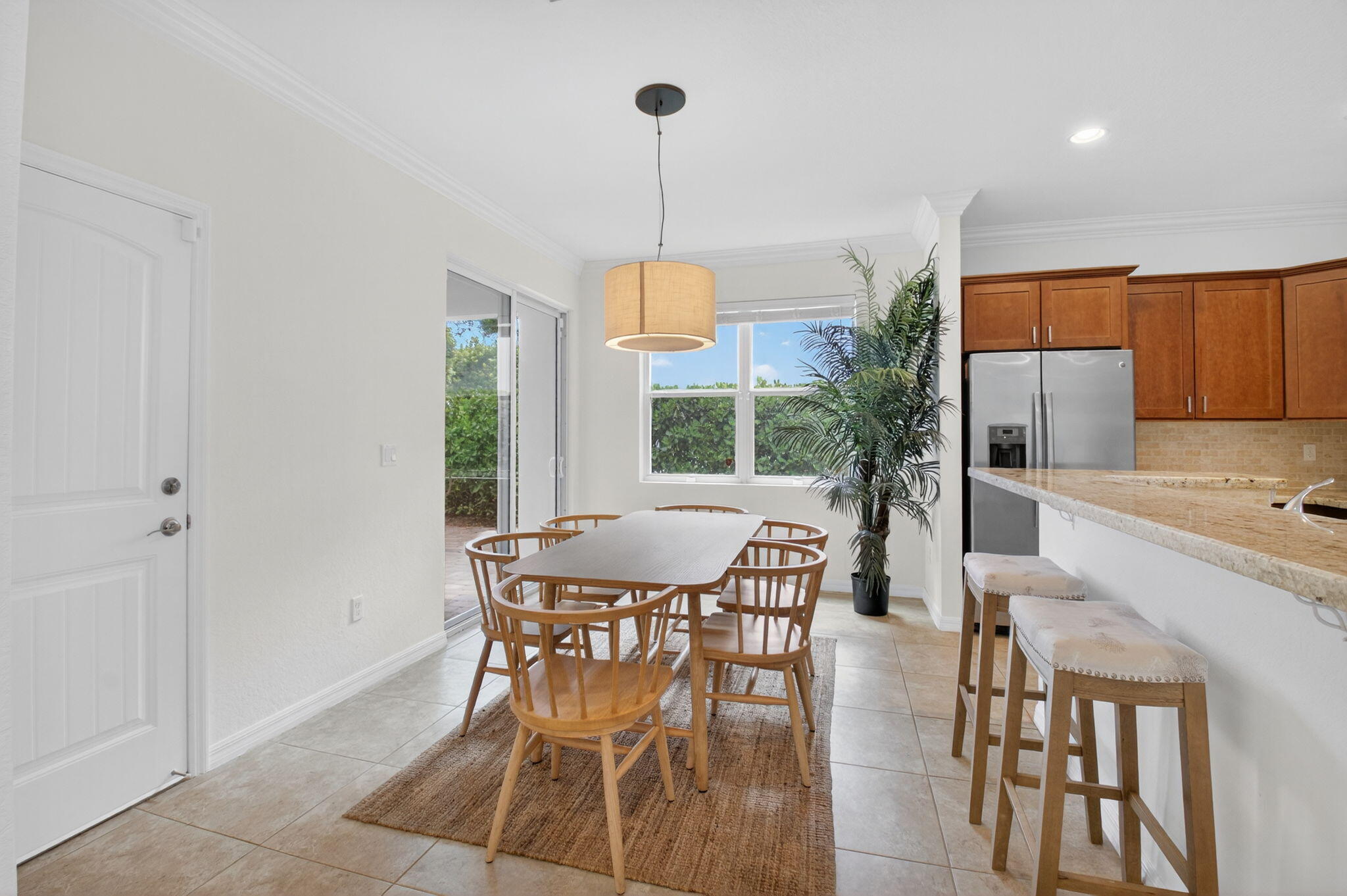 3630 Wolf Run Lane Boynton Beach, FL 33435 - Photo 16 of 59 a dining room with furniture a chandelier and wooden floor