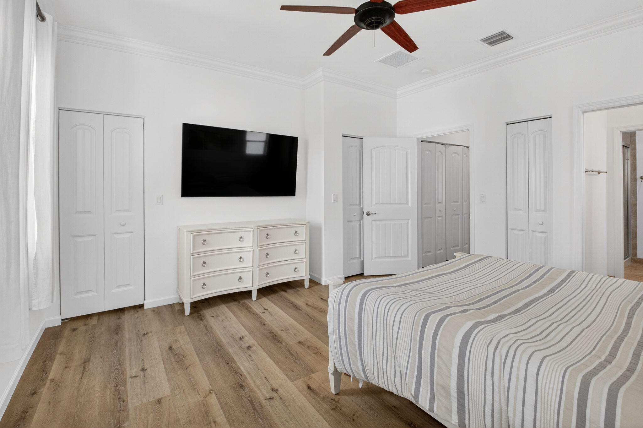 3630 Wolf Run Lane Boynton Beach, FL 33435 - Photo 28 of 59 a bedroom with a bed tv and wooden floor