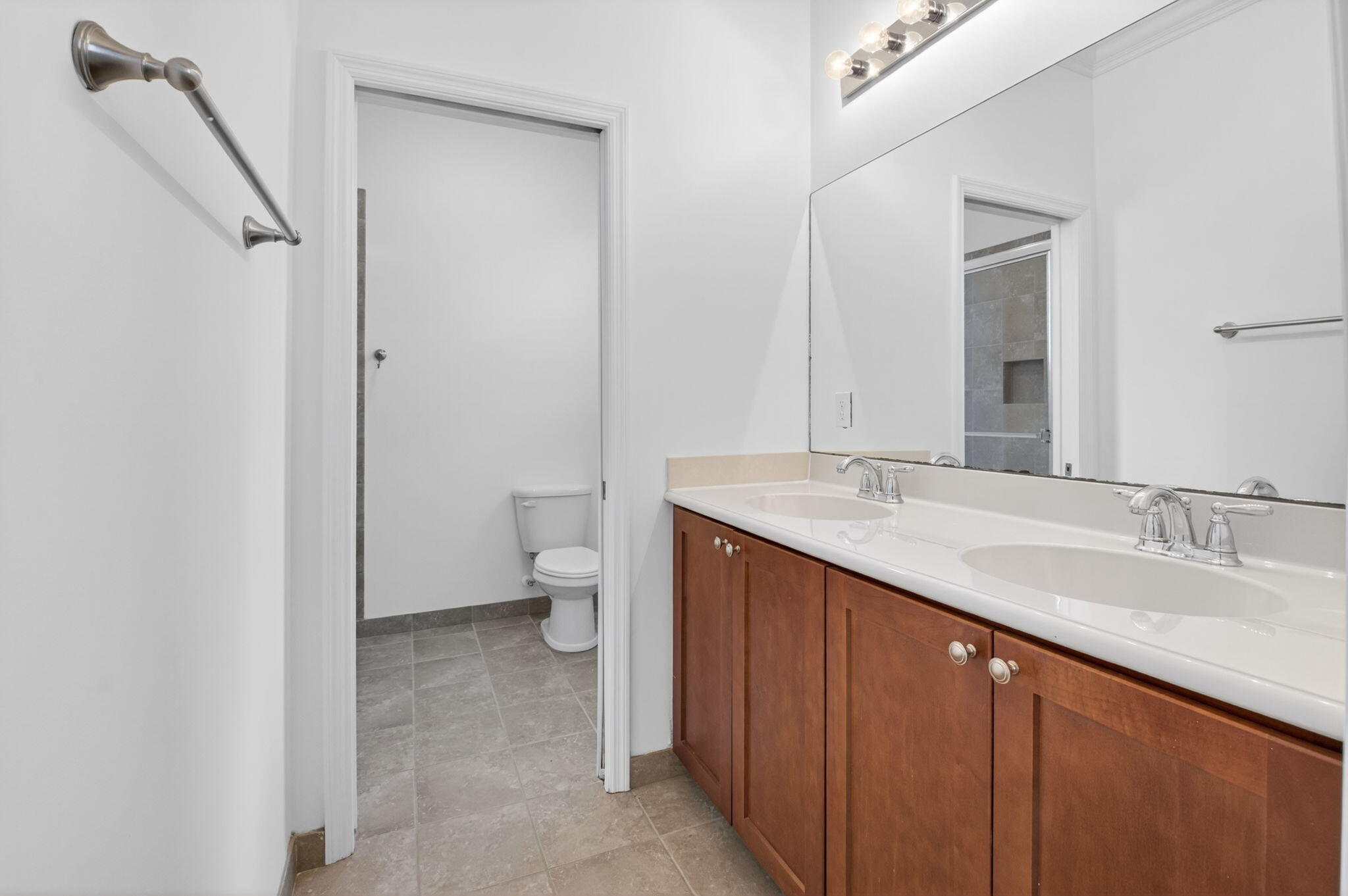 3630 Wolf Run Lane Boynton Beach, FL 33435 - Photo 31 of 59 a spacious bathroom with a granite countertop sink a toilet and a mirror