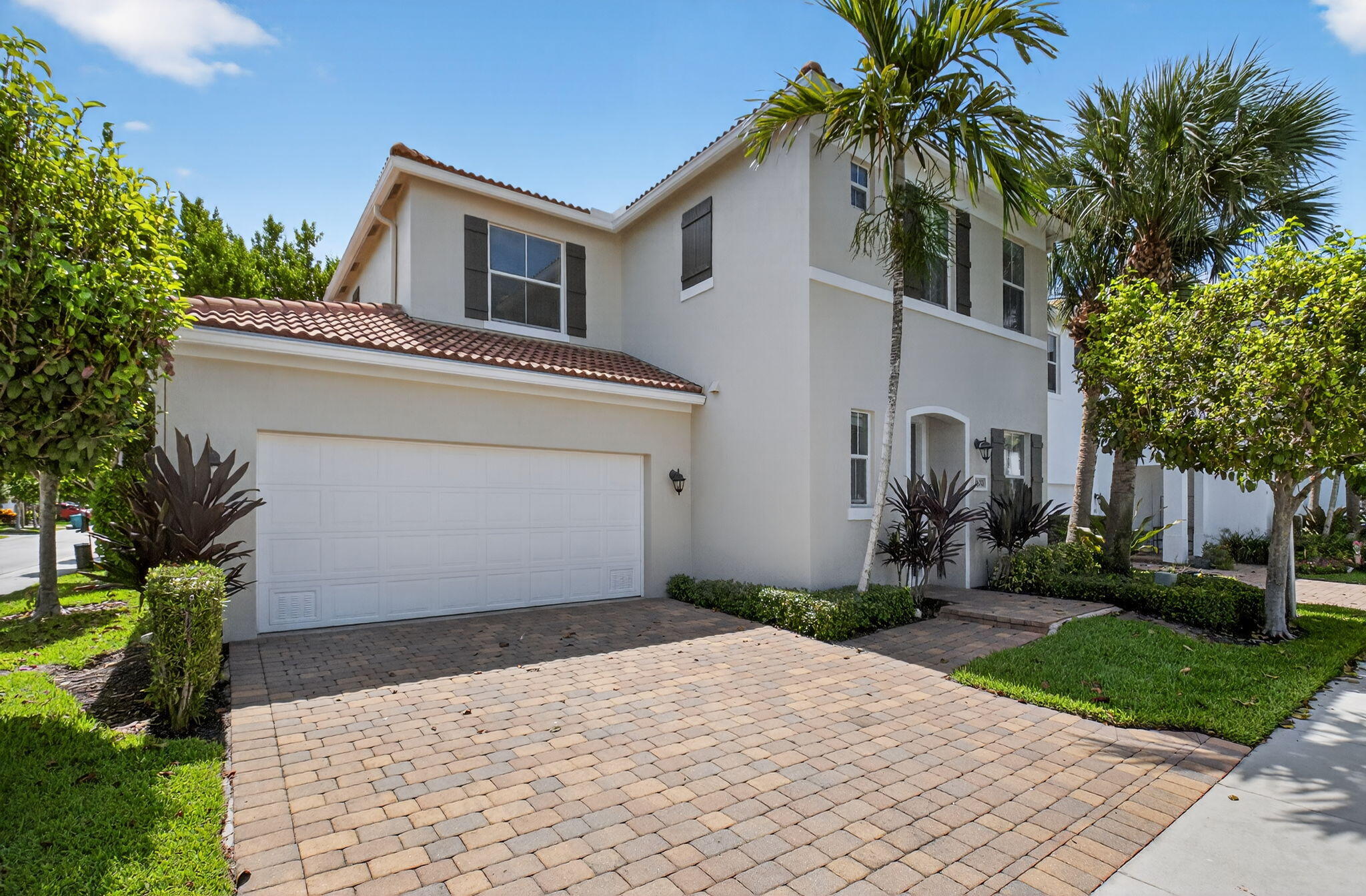 3630 Wolf Run Lane Boynton Beach, FL 33435 - Photo 4 of 59 a front view of a house with a yard and a garage