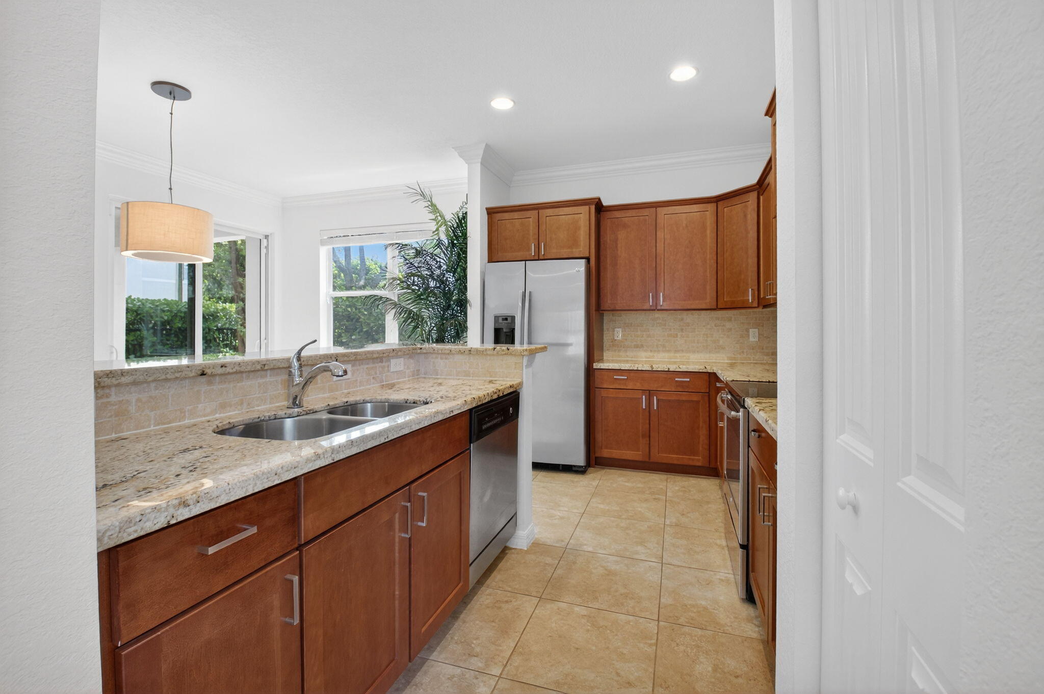 3630 Wolf Run Lane Boynton Beach, FL 33435 - Photo 10 of 59 a kitchen with a sink a counter top space appliances and cabinets