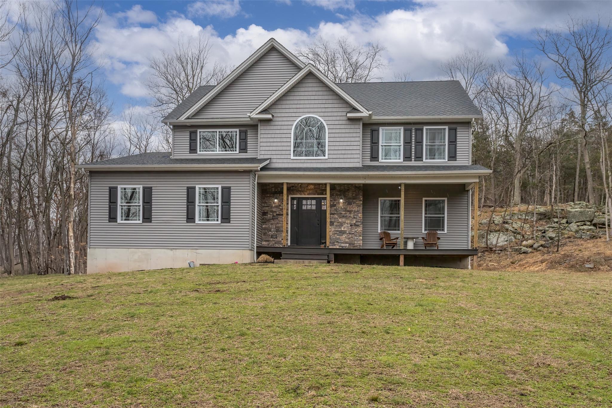 View of front facade with a front yard and a porch