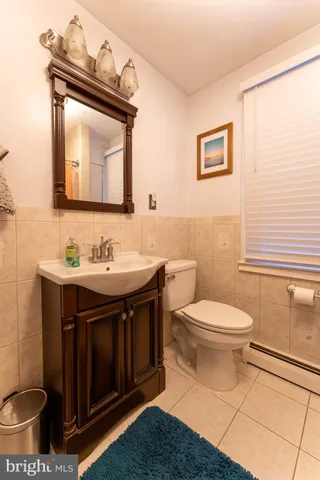 a bathroom with a toilet a sink and mirror