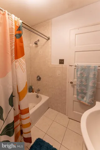 a bathroom with a sink and bathtub with shower