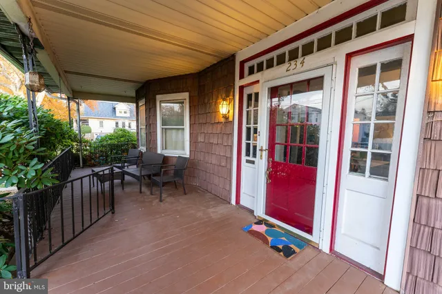 a view of a porch with chairs and couches with wooden floor