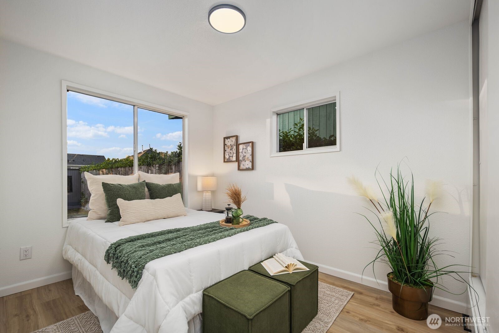 1011 Ironsides Avenue Bremerton, WA 98310 - Photo 14 of 31 a bedroom with a large bed and a potted plant