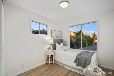 a bed sitting in a bedroom next to a window
