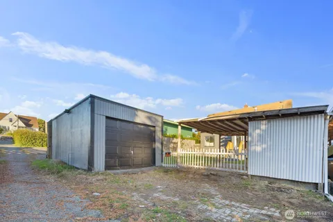 a view of a house with wooden fence