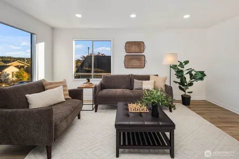 a living room with furniture potted plant and a window