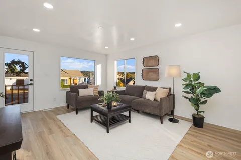 a living room with furniture and a potted plant