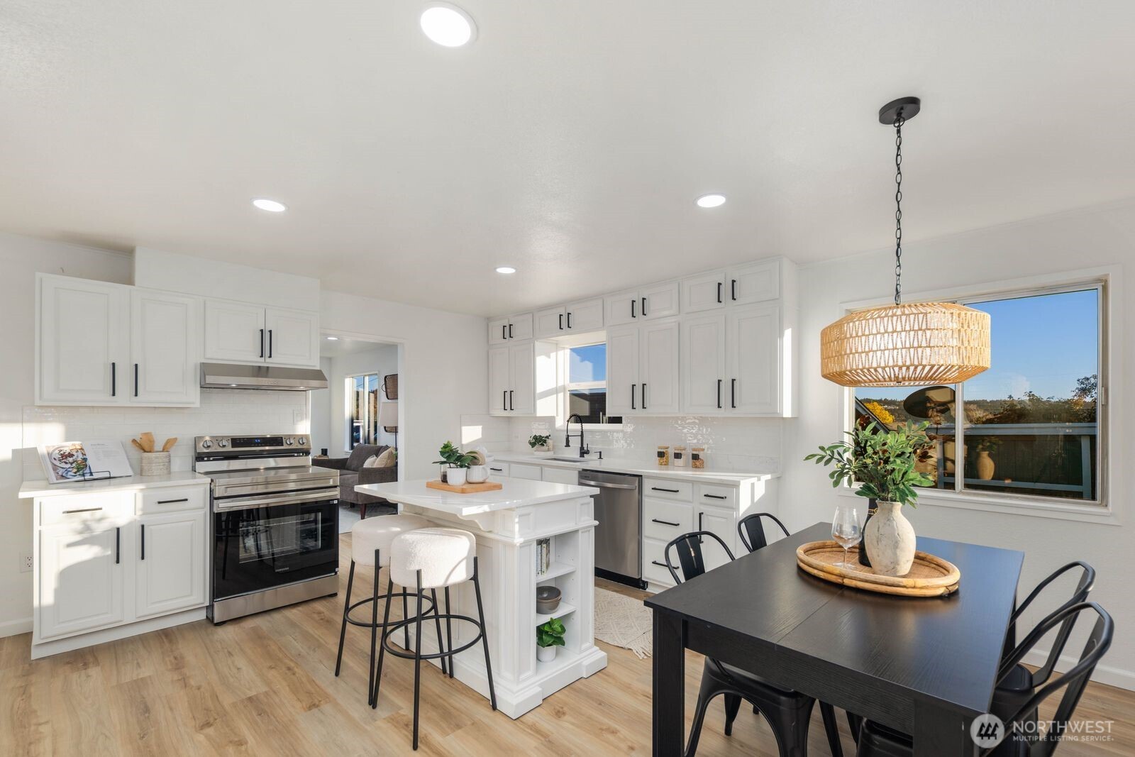 1011 Ironsides Avenue Bremerton, WA 98310 - Photo 9 of 31 a kitchen with refrigerator cabinets dining table and chairs