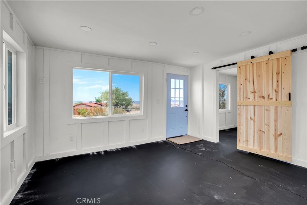 777 Quail Bush Road Landers, CA 92285 - Photo 2 of 46 wooden floor in an empty room with a window