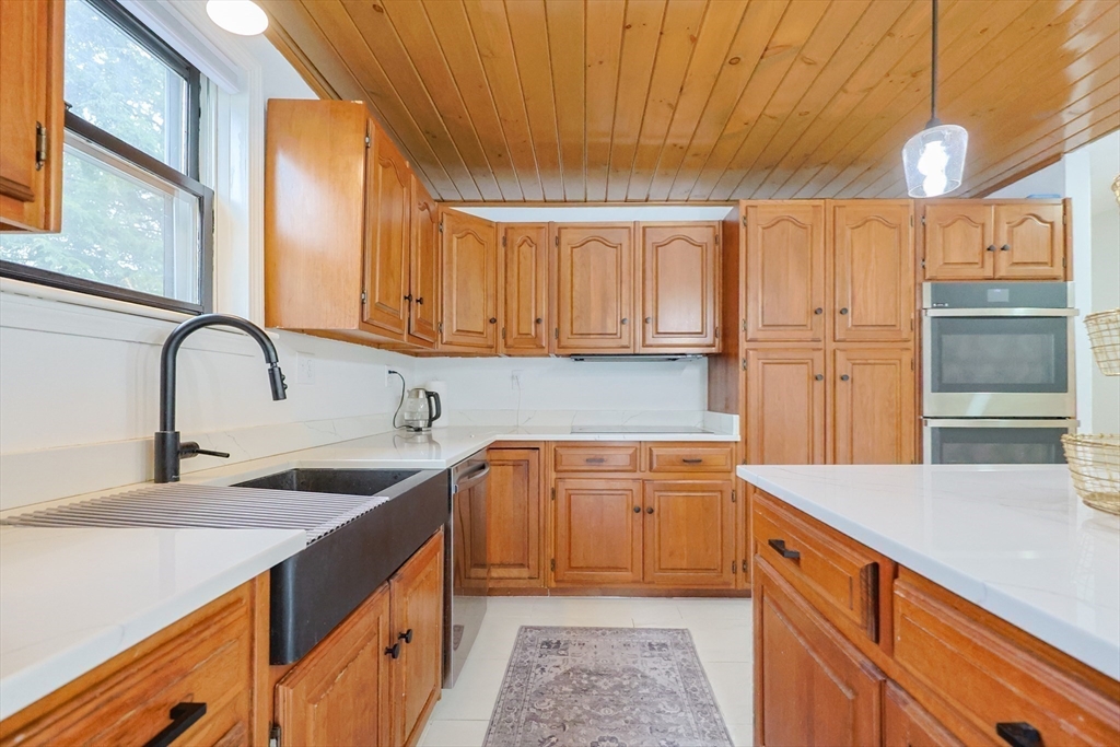 6 Matthew Lane Chelmsford, MA 01824 - Photo 11 of 37 a kitchen with stainless steel appliances granite countertop a sink and cabinets with wooden floor