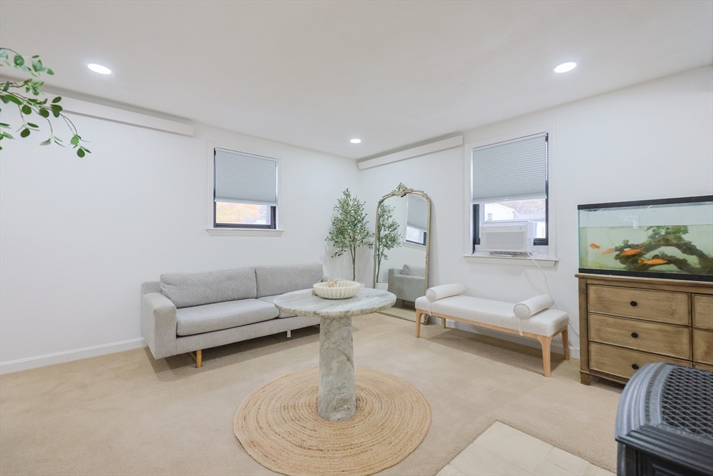 6 Matthew Lane Chelmsford, MA 01824 - Photo 2 of 37 a living room with furniture a rug and a chandelier