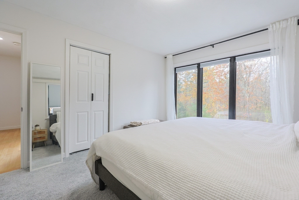 6 Matthew Lane Chelmsford, MA 01824 - Photo 22 of 37 a spacious bedroom with a bed and a large window