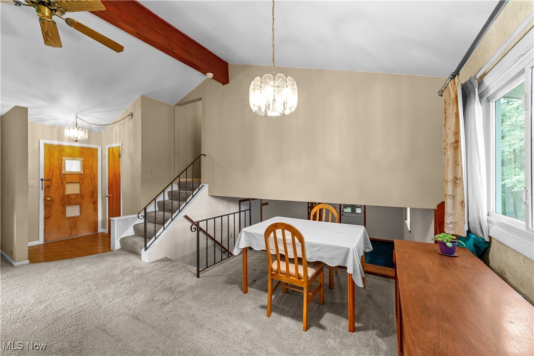 648 Rehwinkle Road Northfield, OH 44067 - Photo 12 of 38 Dining room featuring a chandelier, carpet flooring, a ceiling fan, and stairs
