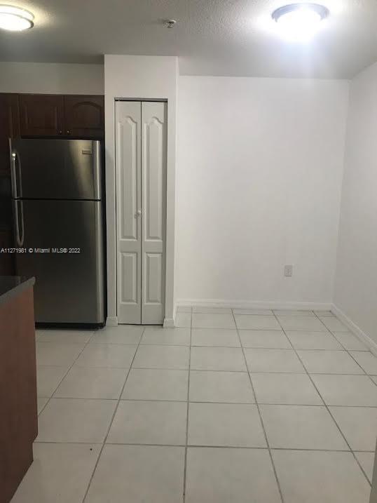 1453 Southwest 3rd Street, Unit 205 Miami, FL 33135 - Photo 4 of 9 a view of a refrigerator in kitchen and empty room