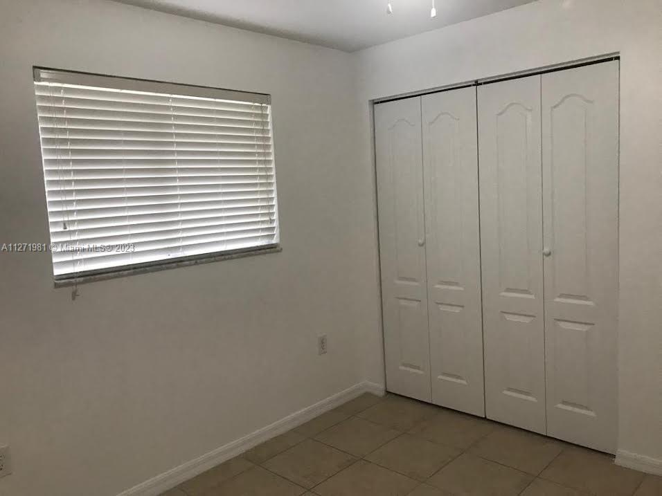 1453 Southwest 3rd Street, Unit 205 Miami, FL 33135 - Photo 6 of 9 an empty room with a window