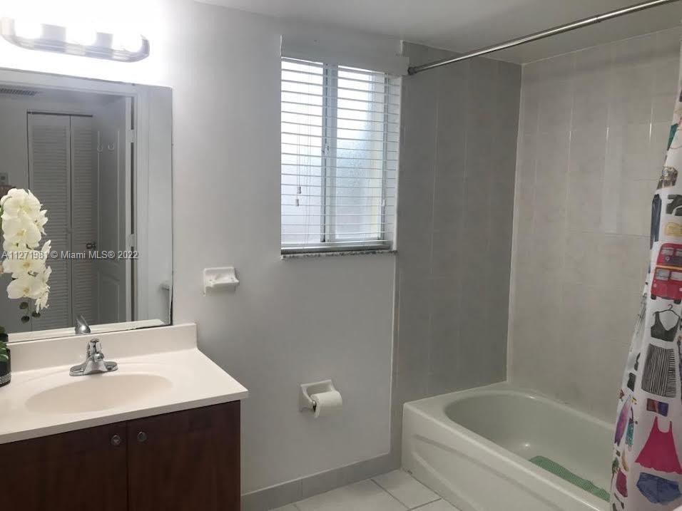 1453 Southwest 3rd Street, Unit 205 Miami, FL 33135 - Photo 7 of 9 a bathroom with a bathtub a sink and a vanity