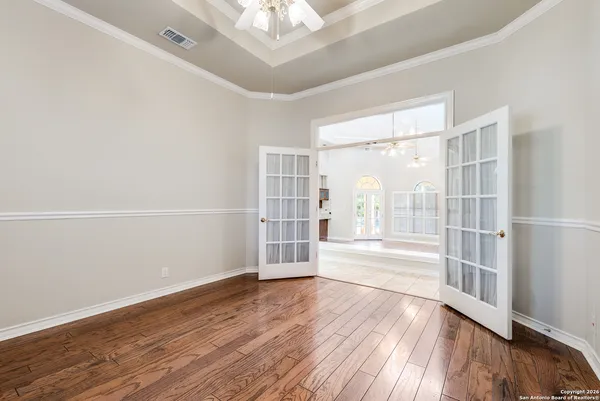 wooden floor in an empty room with a window