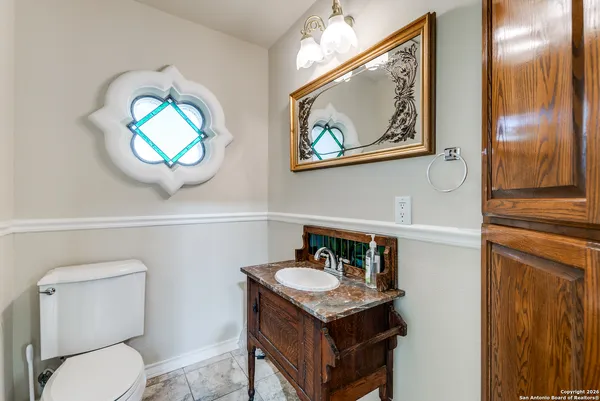 a bathroom with a toilet a sink and mirror