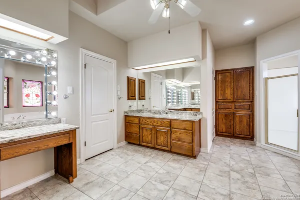 a large bathroom with a granite countertop double vanity sink a mirror and a