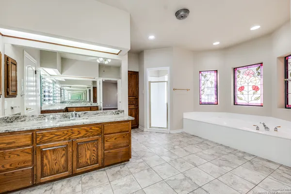 a large bathroom with a large tub and sink