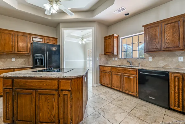 a kitchen with stainless steel appliances granite countertop a sink and cabinets