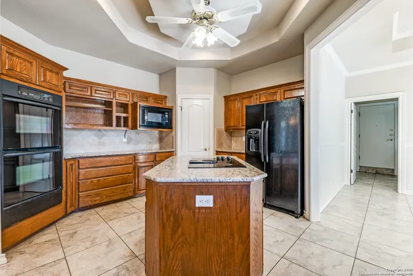 a kitchen with stainless steel appliances granite countertop a refrigerator and a sink