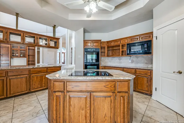 a kitchen with stainless steel appliances granite countertop a sink stove and cabinets