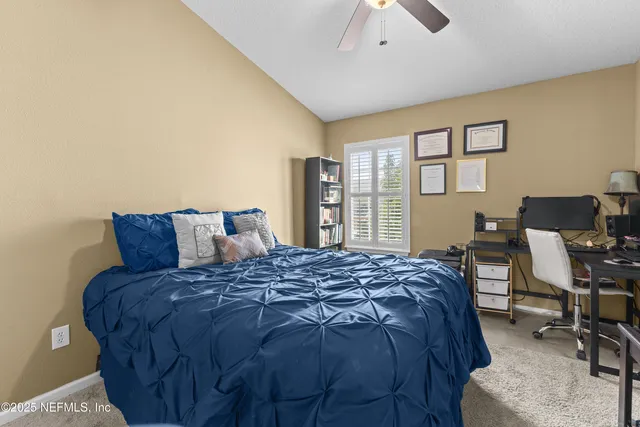 a bed sitting in a bedroom next to a window