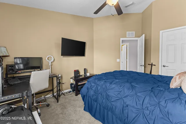 a bedroom with a workspace