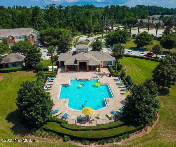 a view of a house with a swimming pool outdoor seating and yard