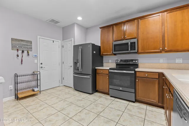a kitchen with a refrigerator stove and microwave