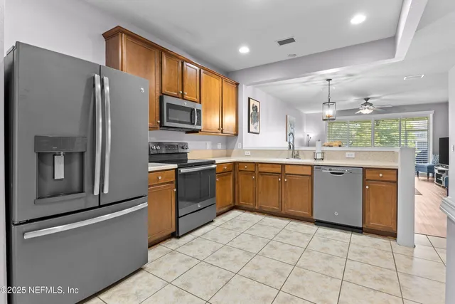 a kitchen with stainless steel appliances granite countertop a stove sink and refrigerator