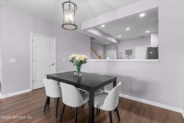 a dining room with furniture and chandelier