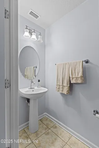 a bathroom with a sink a mirror and vanity