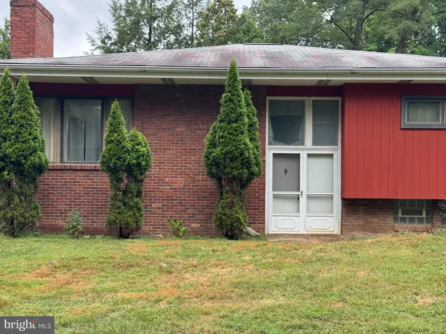 a couple of potted plants in front of door