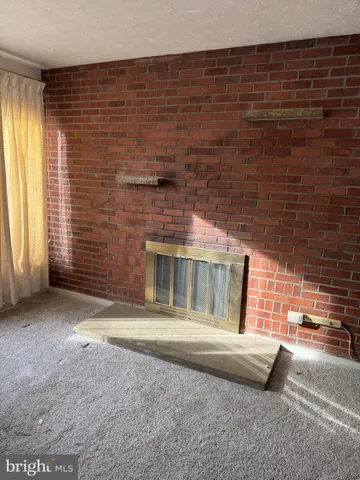 a view of an empty room with a fireplace