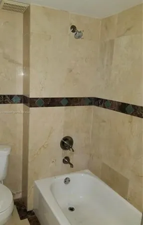 a bathroom with a shower and a toilet