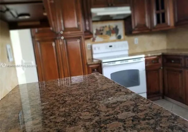 a kitchen with a stove and a refrigerator