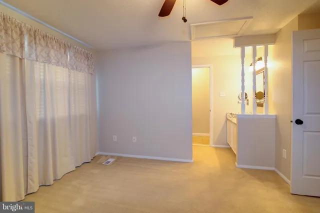 a view of an empty room with a window