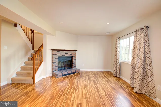 a view of entryway with wooden floor and stairs