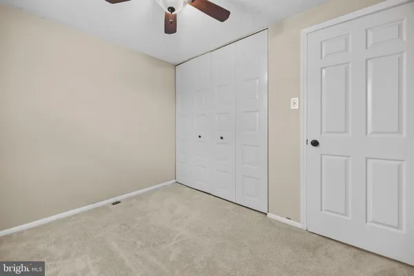 an empty room with a ceiling fan