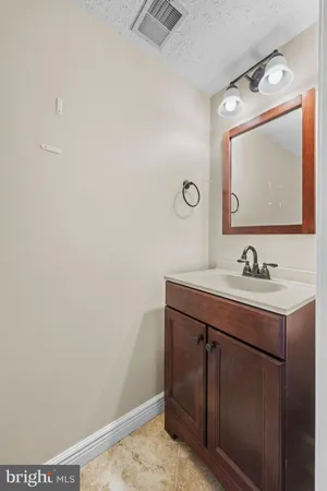 a bathroom with a sink vanity and mirror