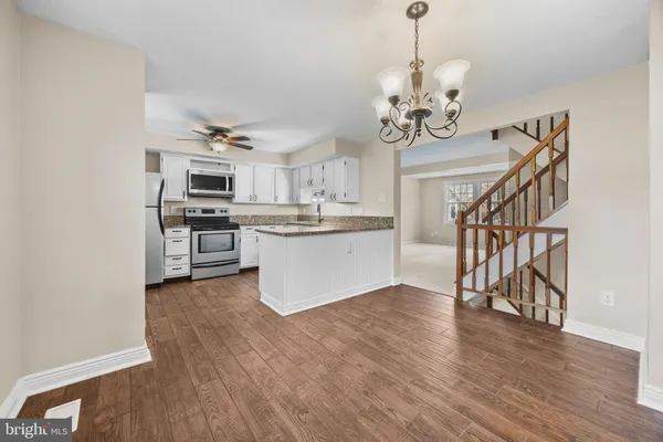 a view of a kitchen with sink and stainless steel appliances