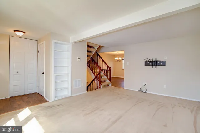 a view of a room with wooden floor